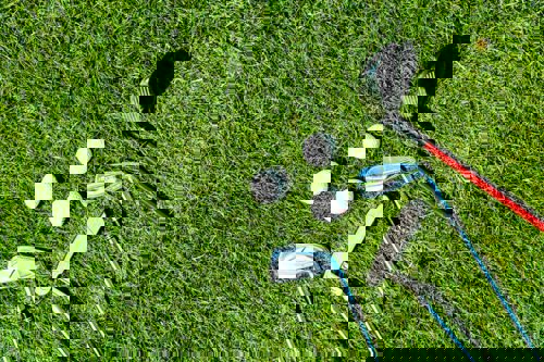 golf-clubs-and-balls-on-green