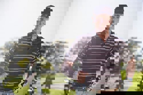 man-stood-golf-course