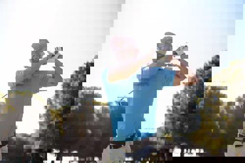 man-swinging-golf-club