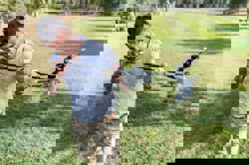 man-lineing-up-golf-club